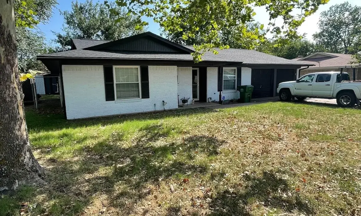 Professional roofing crew working on a residential roof in Ontwa